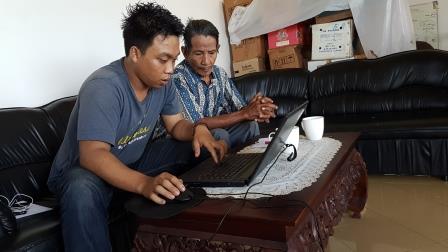Engga and Pak Aron working on a translation